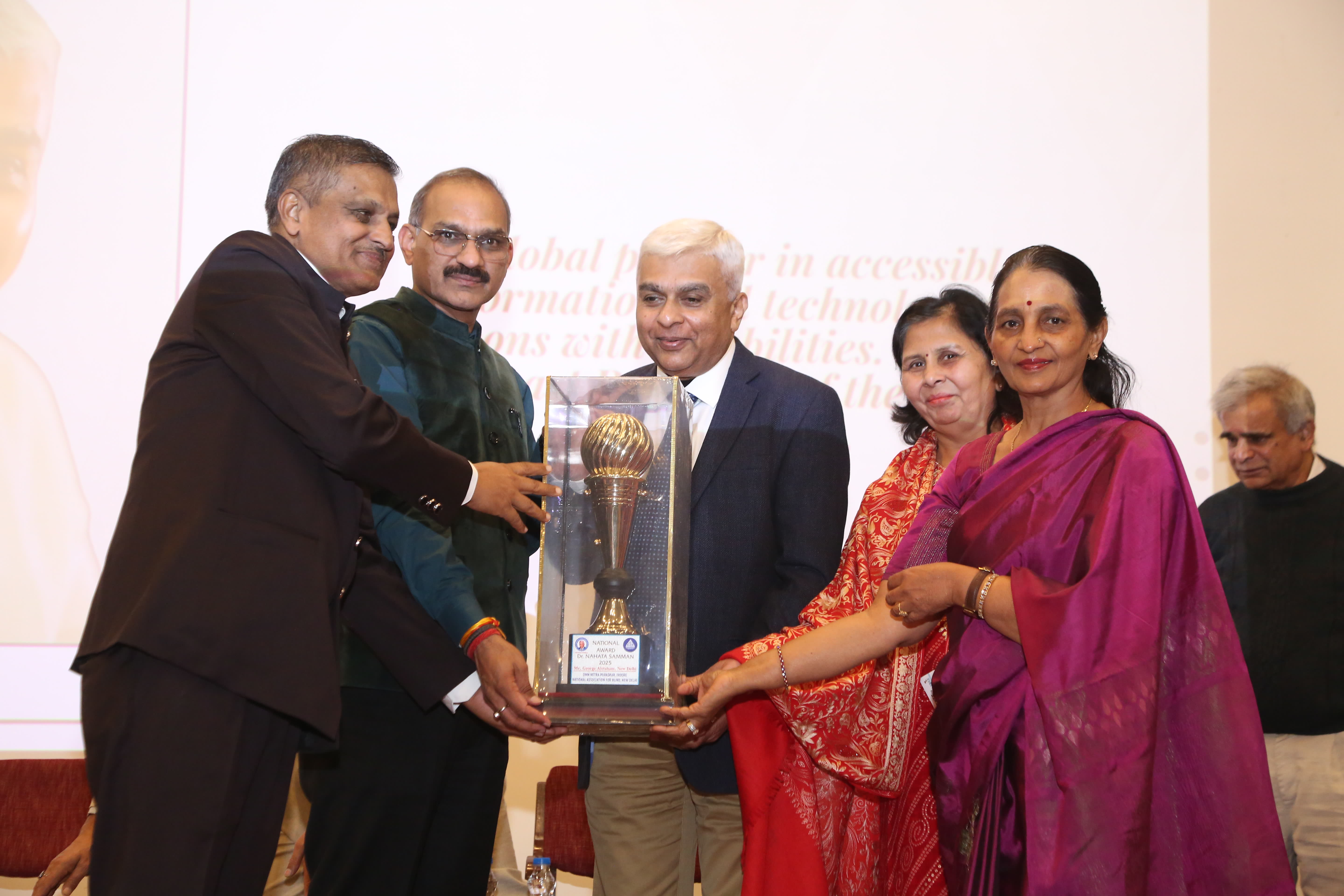 George Abraham receiving an award for his contributions to the disability sector.