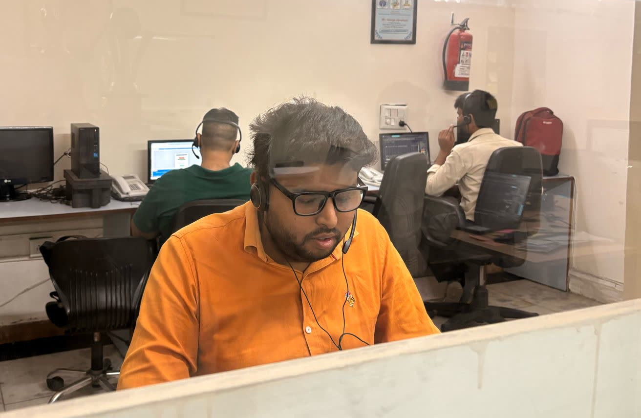 Counselors attending calls and providing support inside the helpline room.